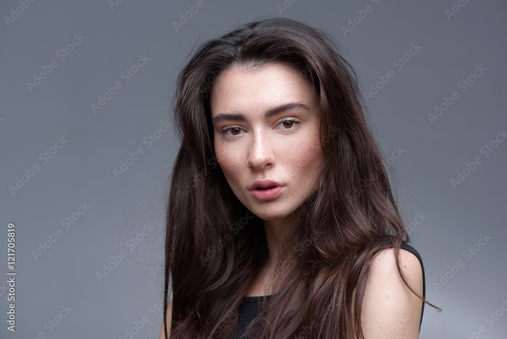brunette posing in the studio, isolated on light grey background brunette posing in the studio, isolated on light grey background