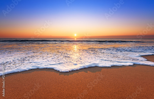 Fototapeta Naklejka Na Ścianę i Meble -  Majestic ocean sunset with a breaking wave.