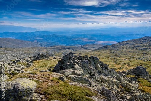 Beautiful panoramic image at Vitosha, Sofia, Bulgaria with vast view across several miles - with jagged rocks in the foreground and mountain chains in the foreground © photoenthusiast
