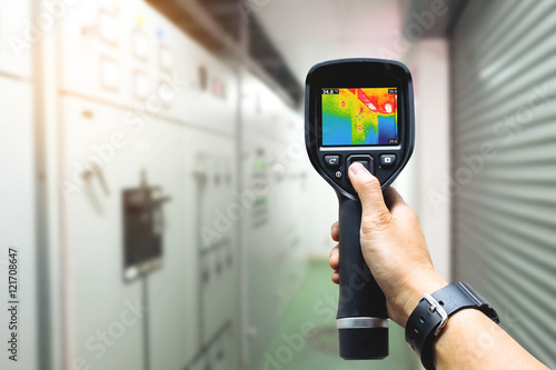 Konstfotografi technician use thermal imaging camera to check temperature in fa