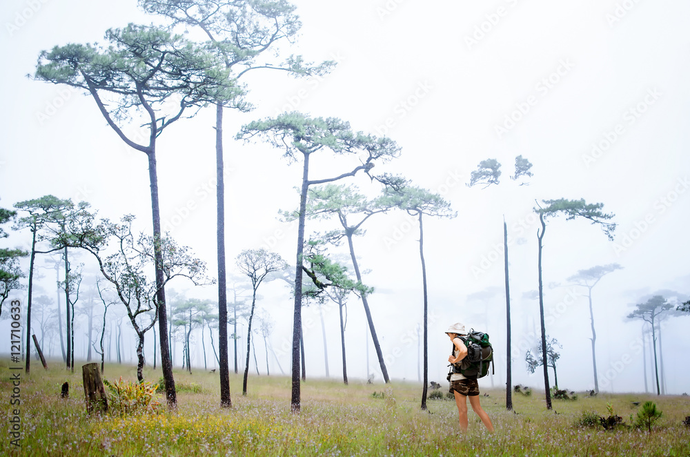 Young backpacker with backpack traveling along rain Young backpacker with backpack traveling along rain