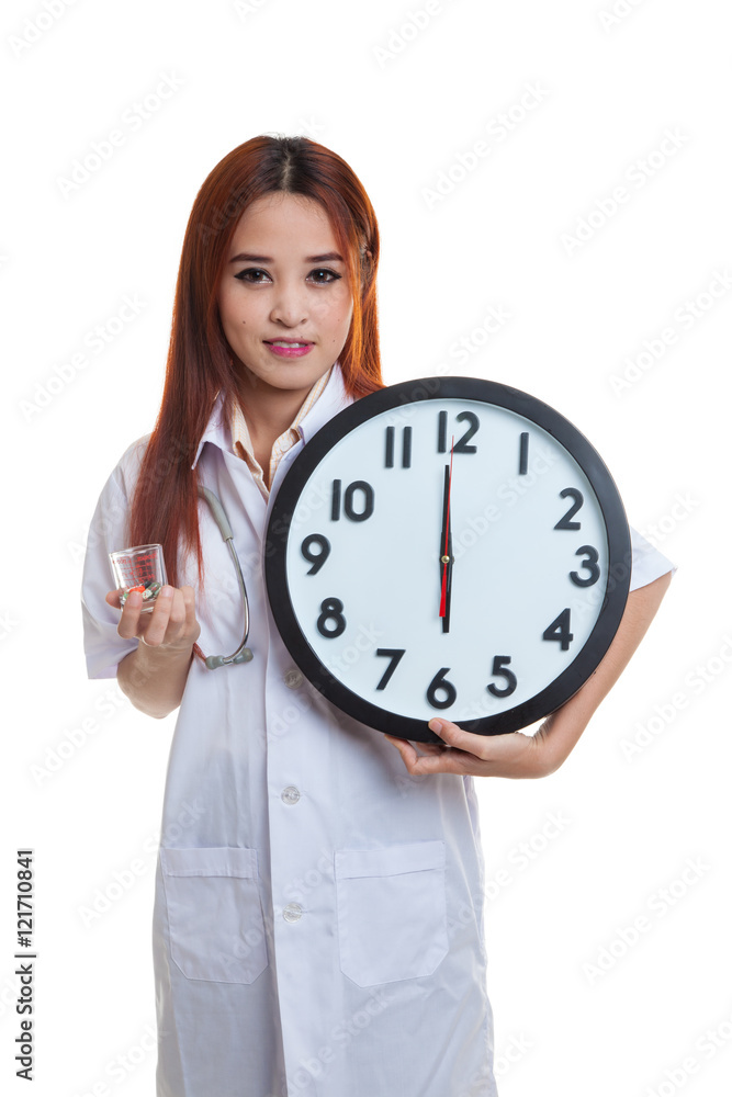 Young Asian female doctor smile with a clock and pills. Young Asian female doctor smile with a clock and pills.