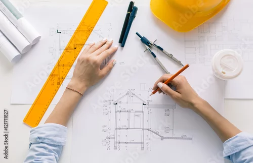 Obraz Architect drawing blueprints, architectural project in progress
