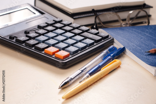 glasses  calculator  Notepad on a white table