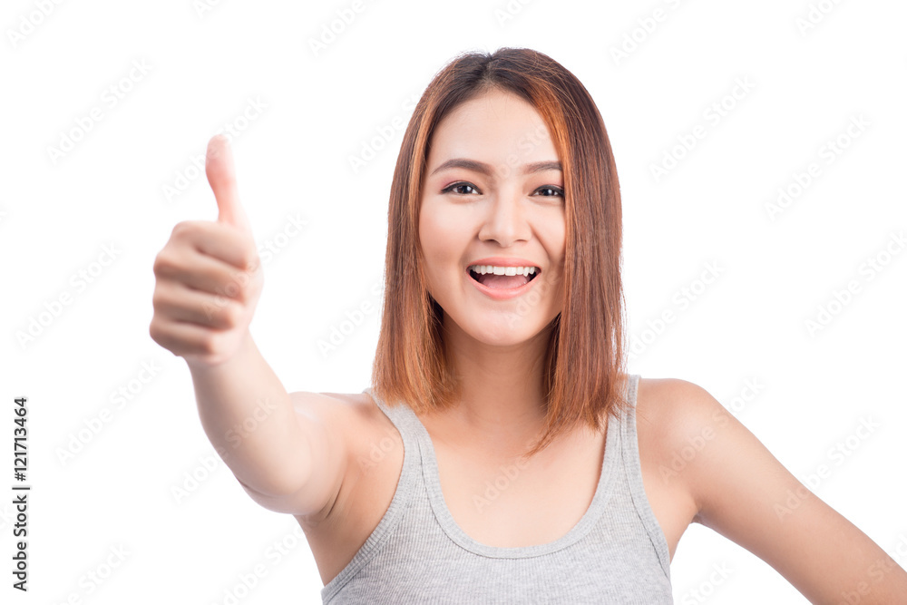 Cheerful lovely girl looking at camera showing thumbs up over wh Cheerful lovely girl looking at camera showing thumbs up over wh