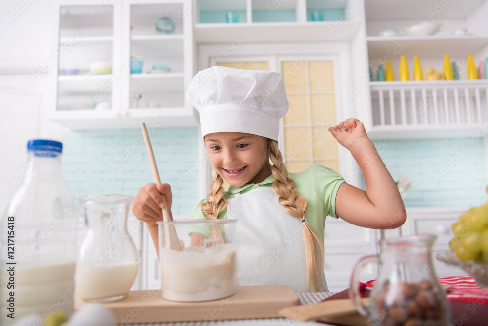 Happy child enjoying baking at home Happy child enjoying baking at home