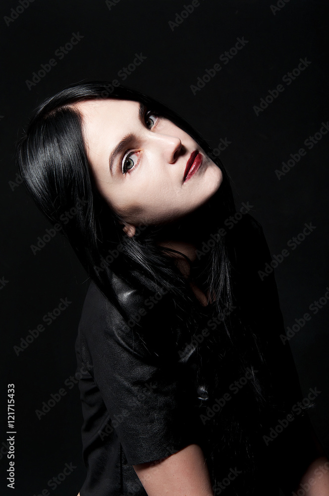 Gorgeous brunette with white skin, red lips on black backdrop Gorgeous brunette with white skin, red lips on black backdrop