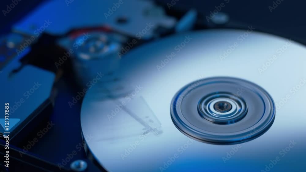 static macro shot of the inside of a modern computer hard disk drive with moving actuator arm reading and writing data from the platters static macro shot of the inside of a modern computer hard disk drive with moving actuator arm reading and writing data from the platters