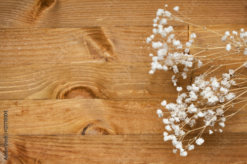 white flowers gypsophila. small white flowers on a wooden background. wood texture. space for text. view from above
