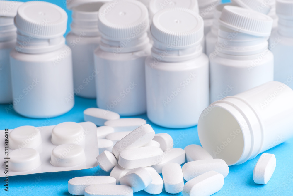 Many pills and tablets isolated on light blue background Many pills and tablets isolated on light blue background