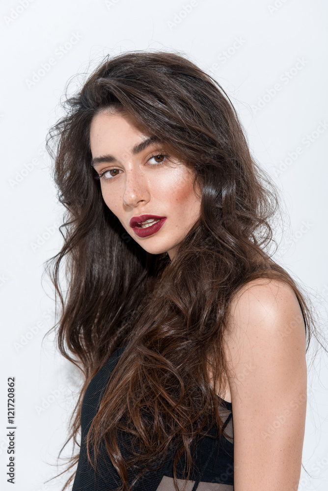 portrait of a young astonished brunette looking into camera portrait of a young astonished brunette looking into camera