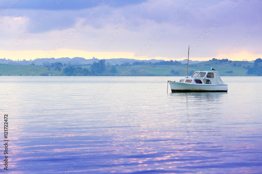 Fototapeta premium Sailboat on water with beautiful landscape at the background.