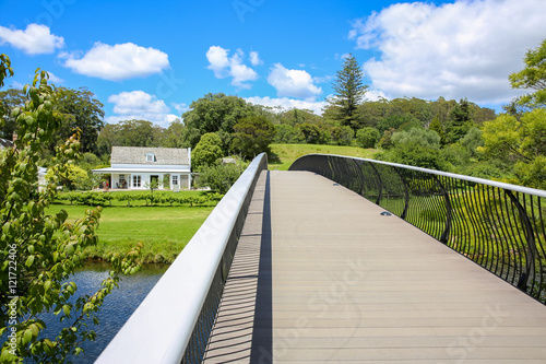 KERIKERI, NZ - JAN 10,2015: View of Historic Mission Station Kemp House from modern metal bridge.