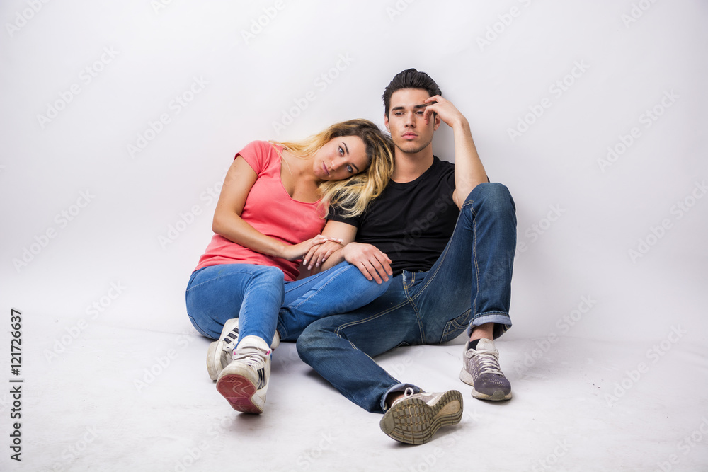 Young couple in love, cuddling, embracing and kissing, studio shot on white background Young couple in love, cuddling, embracing and kissing, studio shot on white background