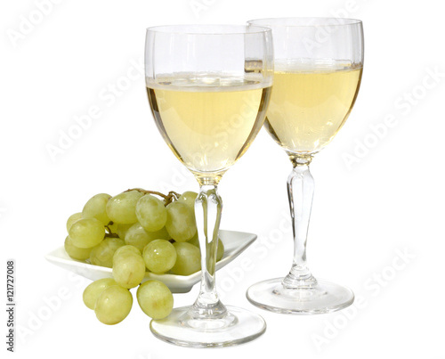 two glasses of sparkling white wine. green grapes on a white plate. isolated on white background