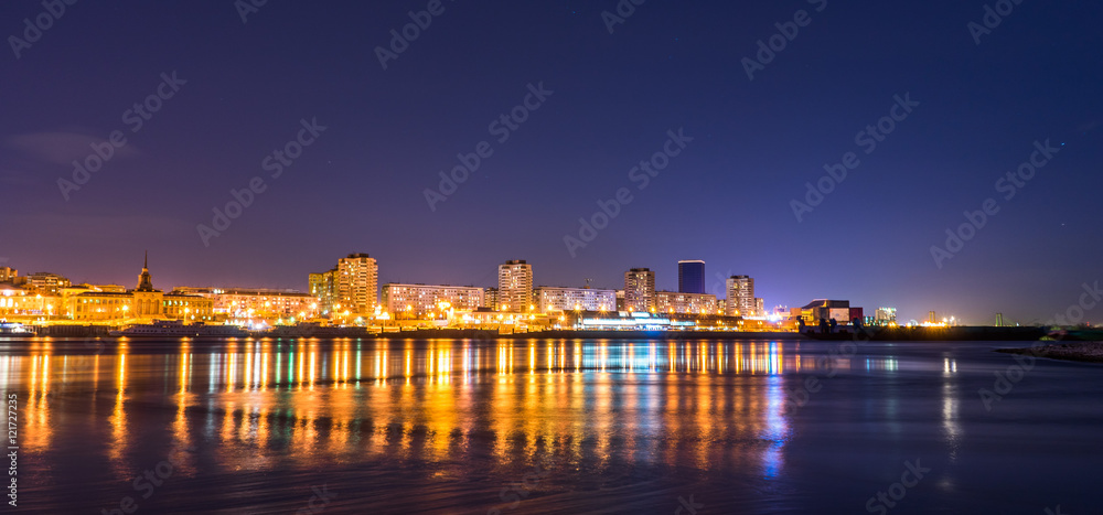 Night city on the river Enisey