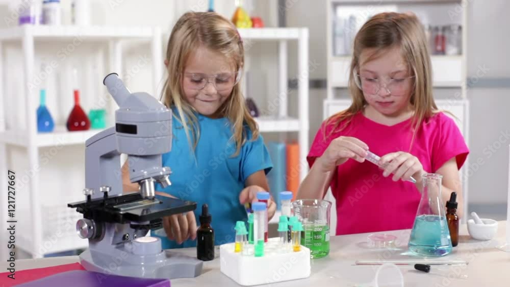 Little girls enjoy working with different liquid while learning about chemistry. Little girls enjoy working with different liquid while learning about chemistry.