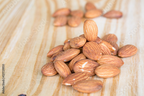 roasted almonds on wooden table photo
