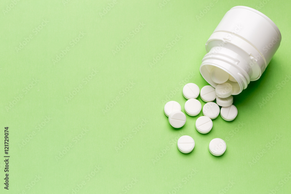 Round white pills and plastic pill bottle Round white pills and plastic pill bottle