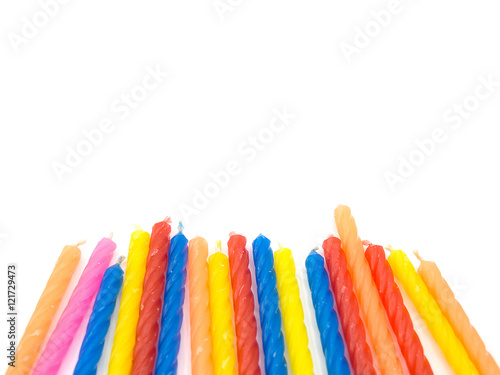 multiple color birthday candles on the white background located