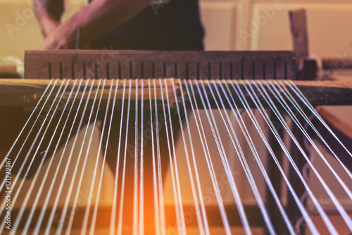 A traditional hand-weaving loom being used to make cloth