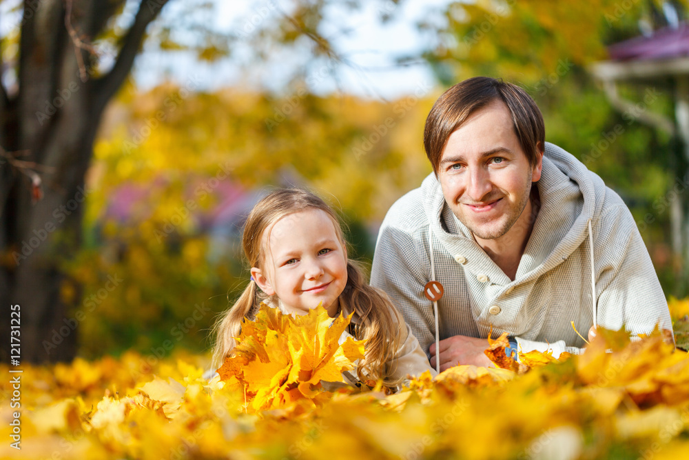 Father and daughter outdoors at autumn day Father and daughter outdoors at autumn day