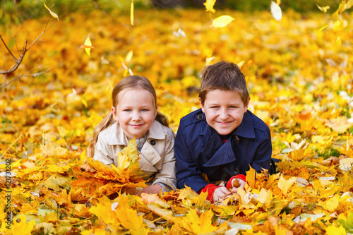 Little kids outdoors in autumn park