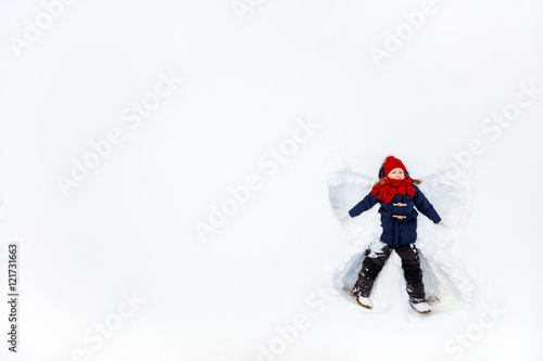 Child girl playing in snow