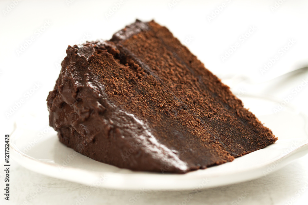 Homemade chocolate cake with cream and dark chocolate, closeup, selective focus, toned Homemade chocolate cake with cream and dark chocolate, closeup, selective focus, toned