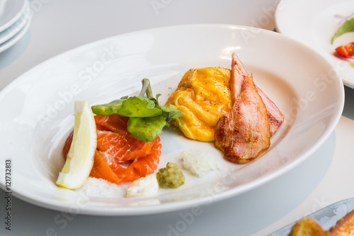Simple healthy breakfast smoked salmon, ham, scrambled eggs
