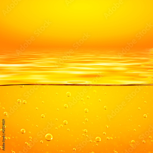 Orange yellow Liquid with oxygen bubbles. Closeup.