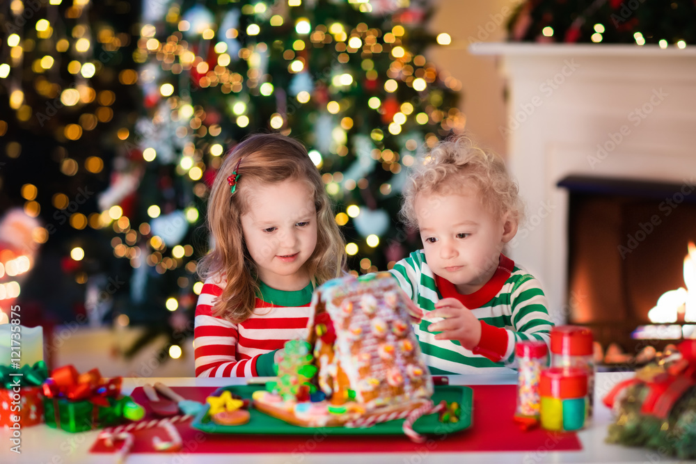 Kids making Christmas ginger bread house Kids making Christmas ginger bread house