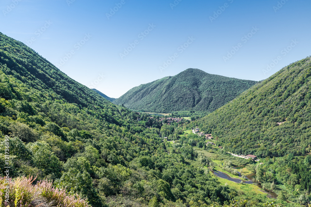 Valganna panorama with Ganna village and the small nature reserve of Lake Ganna located in the park of Campo dei Fiori, province of Varese, Italy 