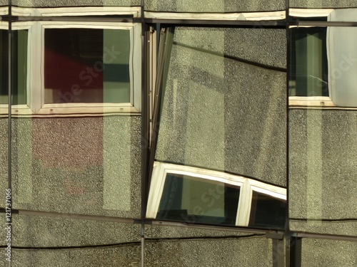 Spiegelung einer Fassade im Stil der Siebzigerjahre in einer modernen Fassade aus Glas auf dem Messegelände der Köln Messe im Stadtteil Deutz in Köln am Rhein in Nordrhein-Westfalen photo