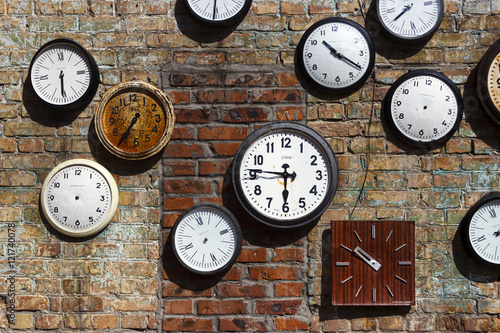 Old clock on the brick wall