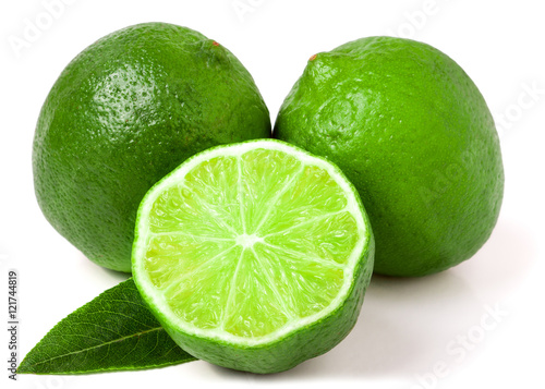 two limes with half and leaf isolated on white background