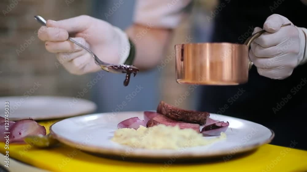 Chef decorate plate with steak. Chef decorate plate with steak.