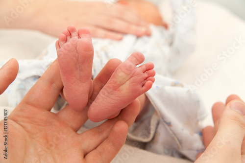 Infant heels in  mother's  hands © annatronova