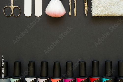 Manicure tools and polish on the dark background