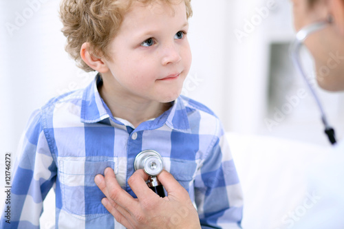 Doctor examining a child patient by stethoscope