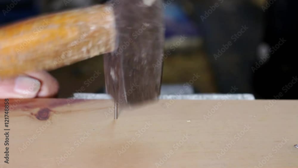 Putting nail into wooden Plank, no sound, low focus Putting nail into wooden Plank, no sound, low focus