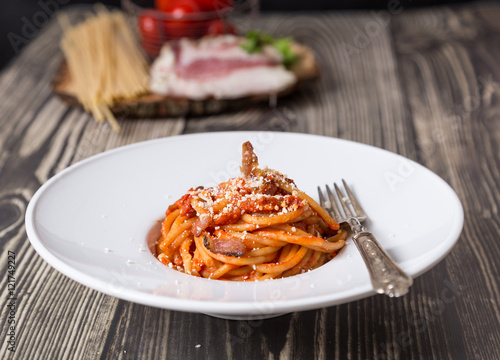 Bucatini all'amatriciana on woden table
