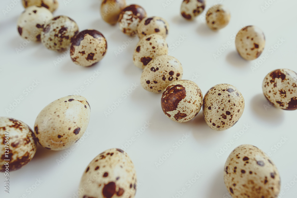 Pile of raw quail eggs isolated on white background
