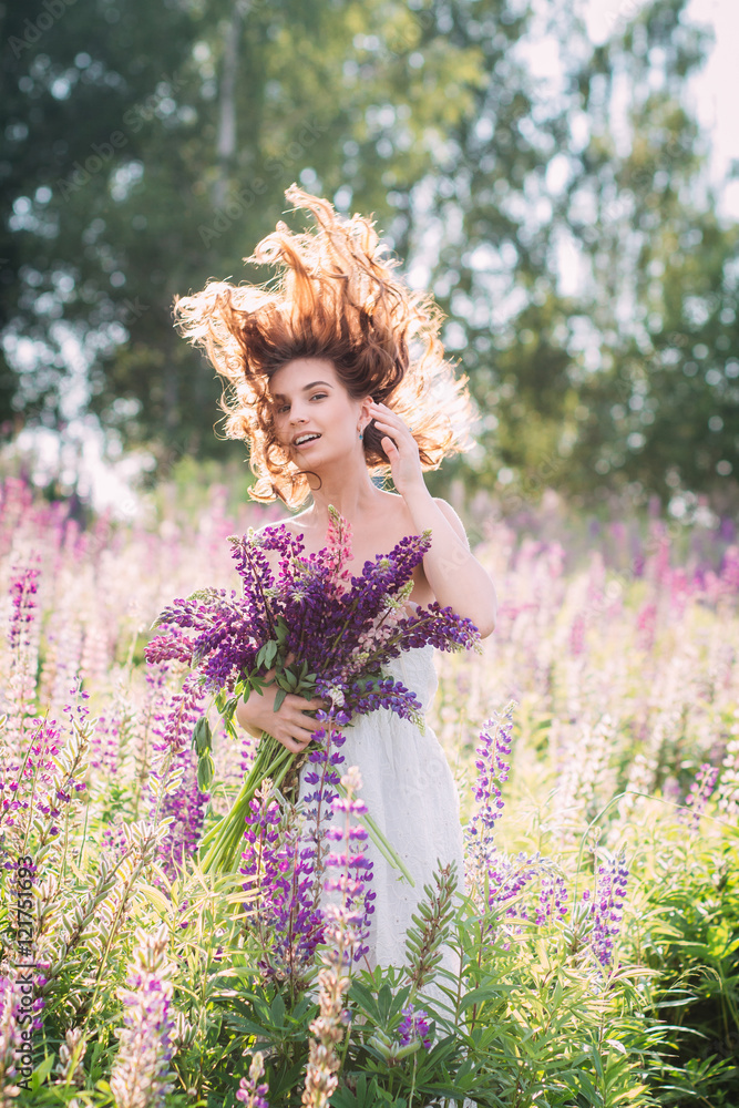 Girl with a bouquet of lupine on the field Girl with a bouquet of lupine on the field