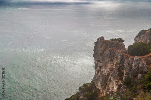 View of cliff and Atlantic ocean on the back in Nazare, Portugal
