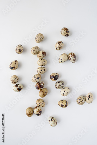 Pile of raw quail eggs isolated on white background 