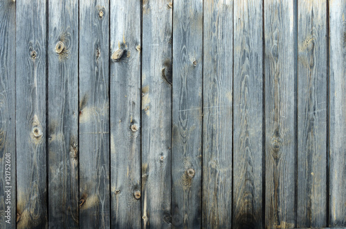 Background from old boards with knots and scratches. traces of the influence of weather. partially tinted photo.