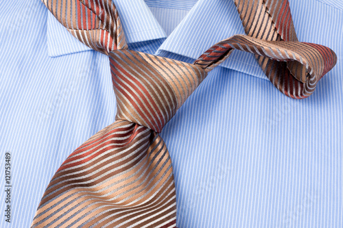 Brown necktie and striped shirt