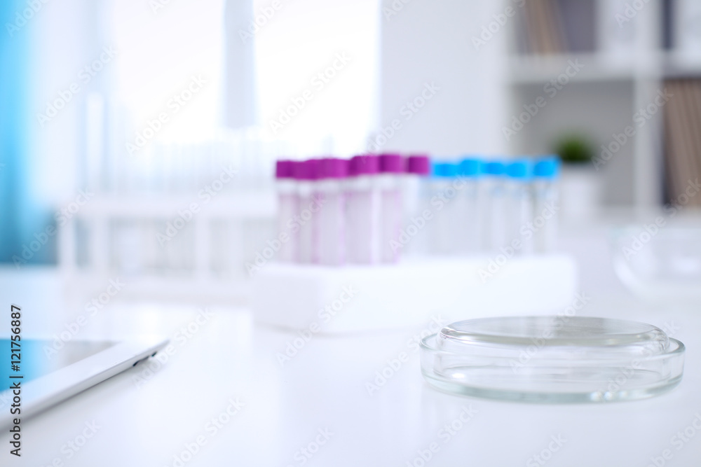 Research laboratory working space. Test tubes and tablet PC are lying at the table. Medical equipment. Blood test Research laboratory working space. Test tubes and tablet PC are lying at the table. Medical equipment. Blood test