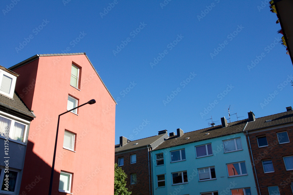 Row of houses against a blue sky in Aachen, Germany